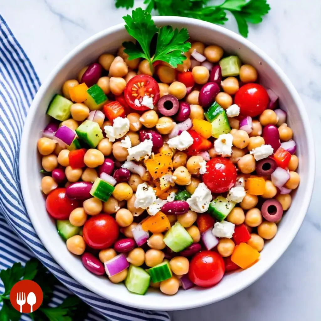 Delicious and vibrant dense bean salad served on a wooden table with lemon and parsley on the side.